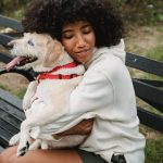 woman hugging her dog outdoors