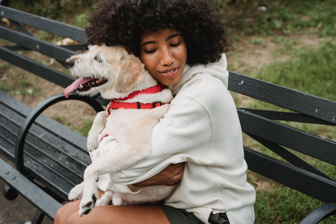 woman hugging her dog outdoors