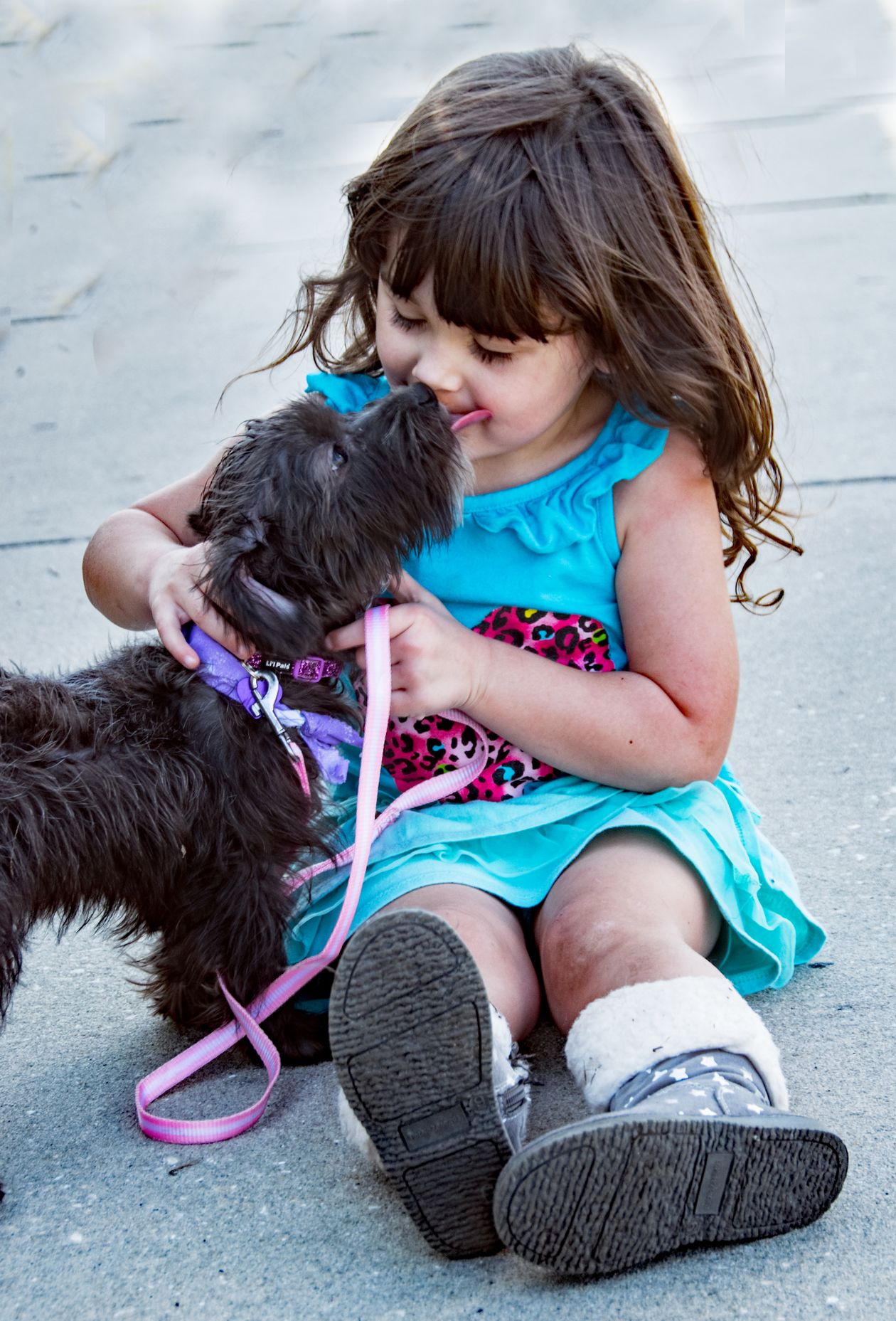 dog sitting beside a little girl on the floor
